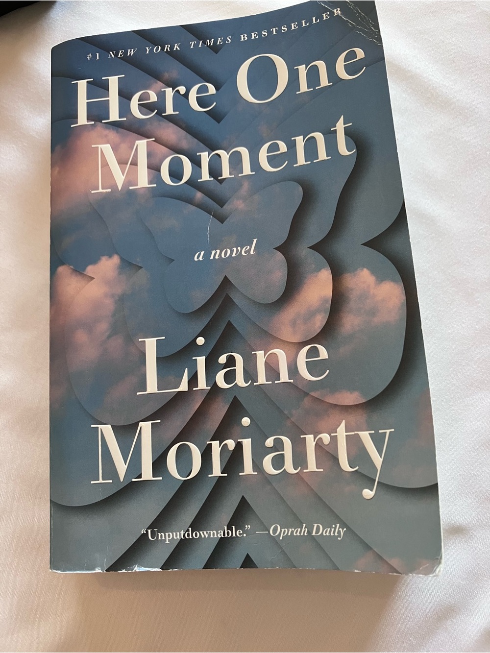 “Here One Moment” by Liane Moriarty- NY Times best selling author. Trade size PB